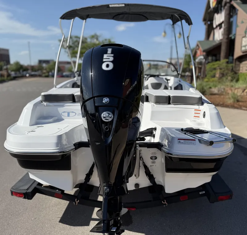 Slide: The Image of 2024 Tahoe 200 S boat with 150 HP engine, parked on a sunny street. - 5