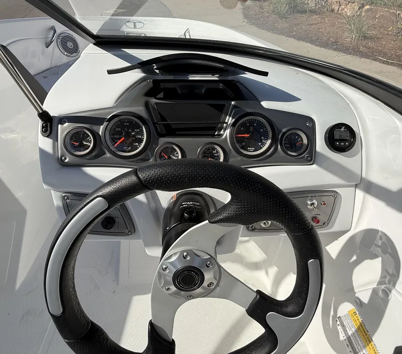 Slide: The Image of 2024 Tahoe 200 S boat dashboard with steering wheel and instrument panel. - 7