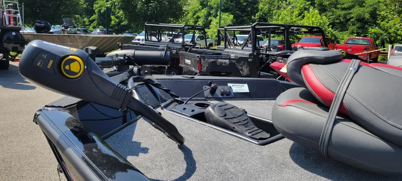 Slide: The Image of 2024 Ranger RT188 boat interior with steering controls and seating, parked outdoors. - 4