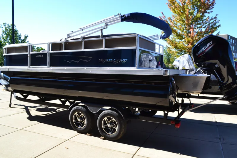 The Image of 2024 Ranger Reata 200C pontoon boat on trailer, featuring Mercury outboard motor. - 0