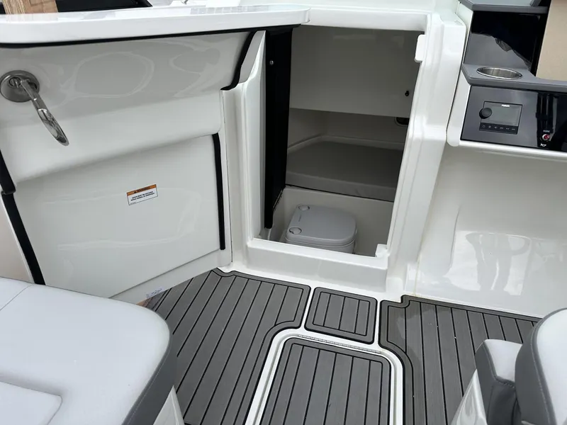 Slide: The Image of 2024 Sea Ray SDX 250 Outboard interior with open storage compartment and modern design. - 10