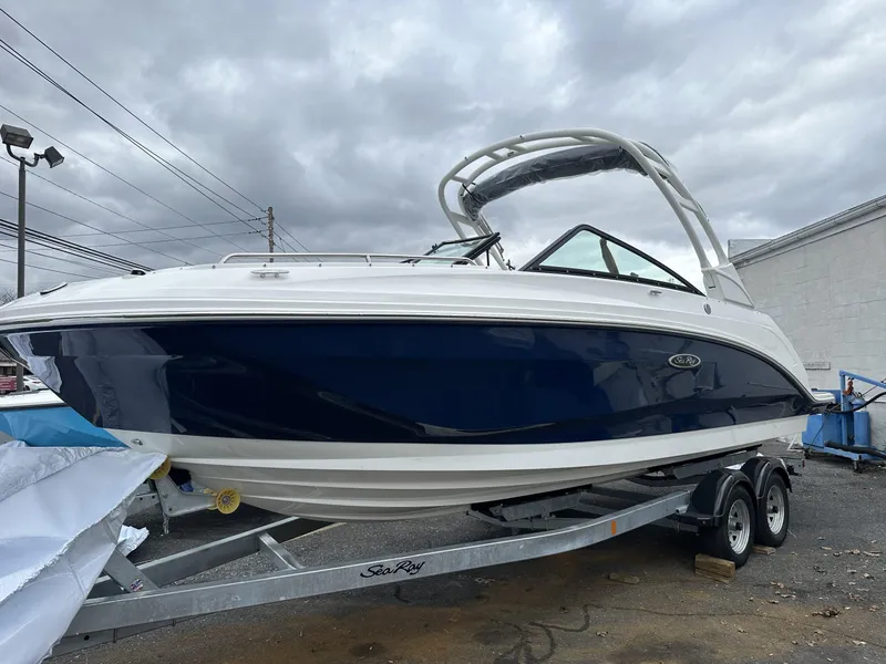 Slide: The Image of 2024 Sea Ray SDX 250 Outboard boat on trailer, under cloudy sky. - 3