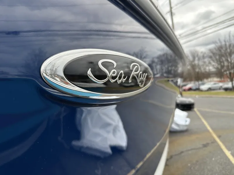 Slide: The Image of Close-up of 2024 Sea Ray SDX 250 Outboard logo on blue boat exterior. - 4