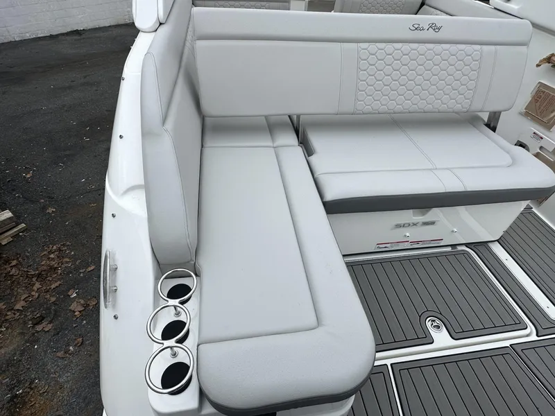 Slide: The Image of 2024 Sea Ray SDX 250 Outboard boat seating with cup holders and stylish upholstery. - 6