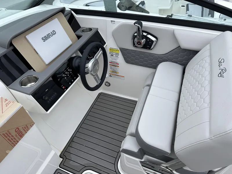 Slide: The Image of 2024 Sea Ray SDX 250 Outboard helm with Simrad display and luxurious seating. - 8