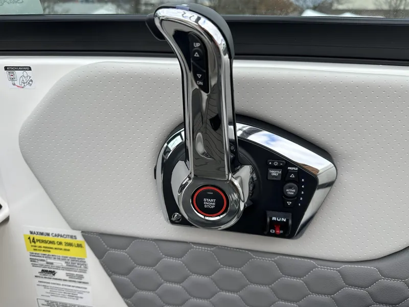 Slide: The Image of 2024 Sea Ray SDX 250 Outboard throttle control with start/stop button and capacity label. - 9