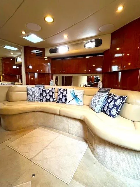 Slide: The Image of Luxurious 2003 Sea Ray 38 Sundancer interior with plush seating and decorative pillows. - 10