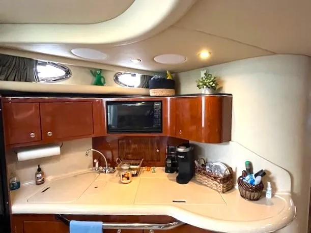 Slide: The Image of 2003 Sea Ray 38 Sundancer yacht kitchen with wood cabinets and modern appliances. - 11