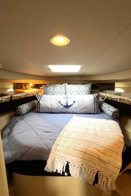Slide: The Image of Cozy cabin interior of 2003 Sea Ray 38 Sundancer with nautical-themed bedding. - 12