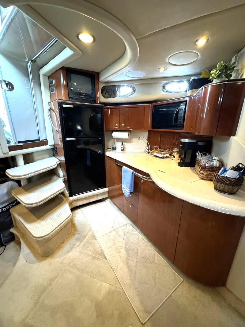 Slide: The Image of Luxurious 2003 Sea Ray 38 Sundancer yacht interior with modern kitchen amenities. - 14