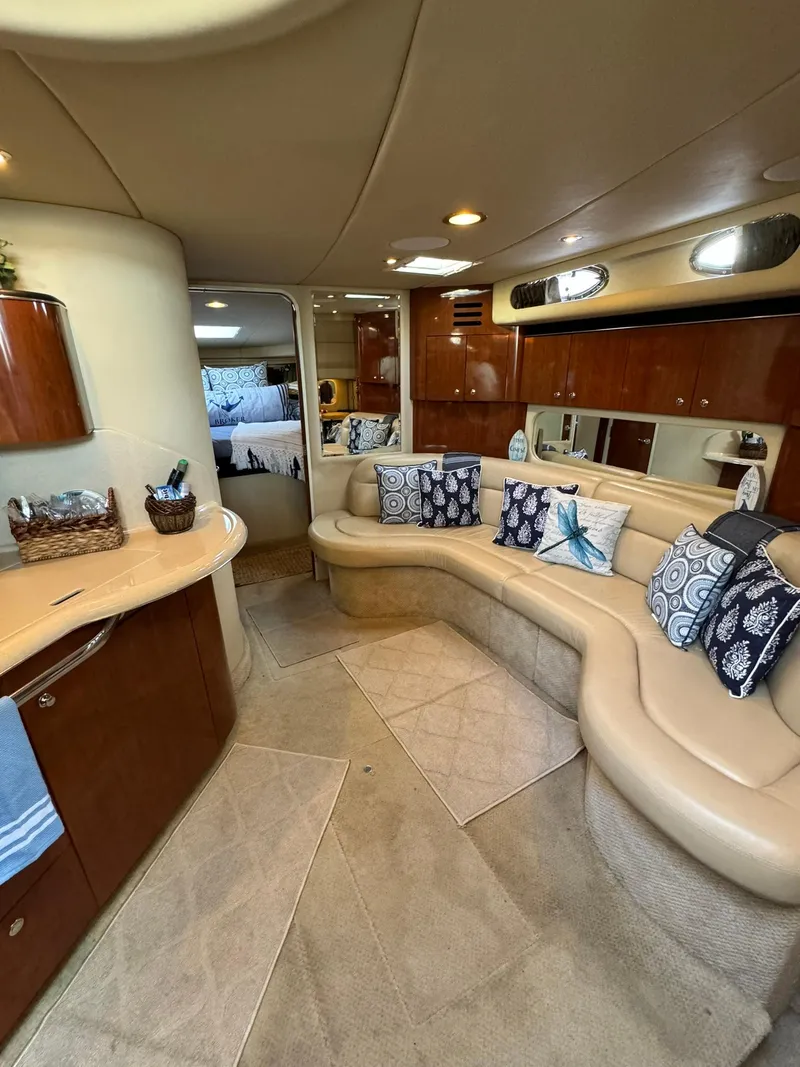Slide: The Image of Luxurious interior of 2003 Sea Ray 38 Sundancer yacht with plush seating and elegant decor. - 16