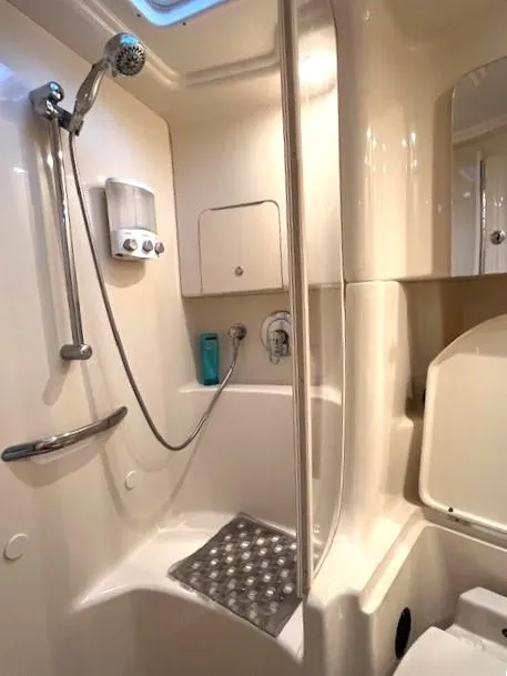 Slide: The Image of 2003 Sea Ray 38 Sundancer bathroom with shower, sleek design, and modern fixtures. - 17