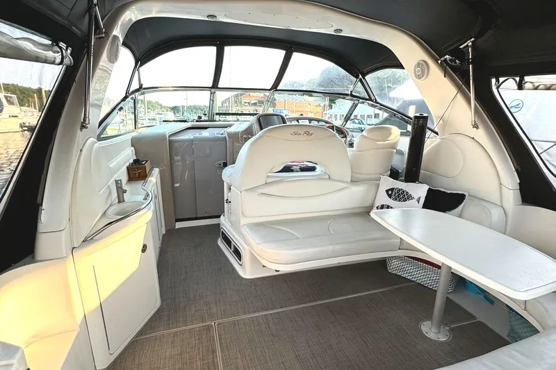 Slide: The Image of Interior of 2003 Sea Ray 38 Sundancer yacht with white seating and table. - 3