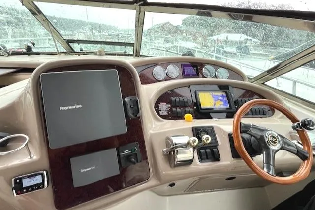 Slide: The Image of 2003 Sea Ray 38 Sundancer helm with navigation equipment and wooden steering wheel. - 6