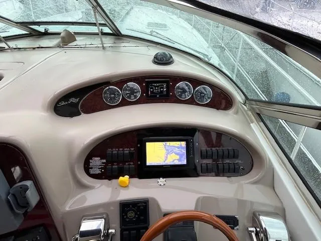 Slide: The Image of 2003 Sea Ray 38 Sundancer helm with navigation controls and gauges. - 7