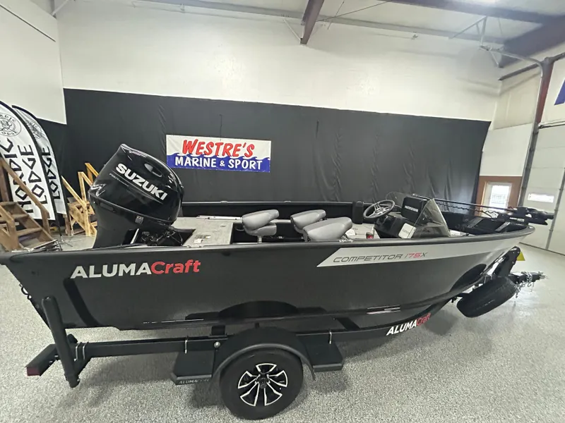 Slide: The Image of 2025 Alumacraft Competitor 175X CS boat with Suzuki engine at Westre's Marine & Sport showroom. - 1