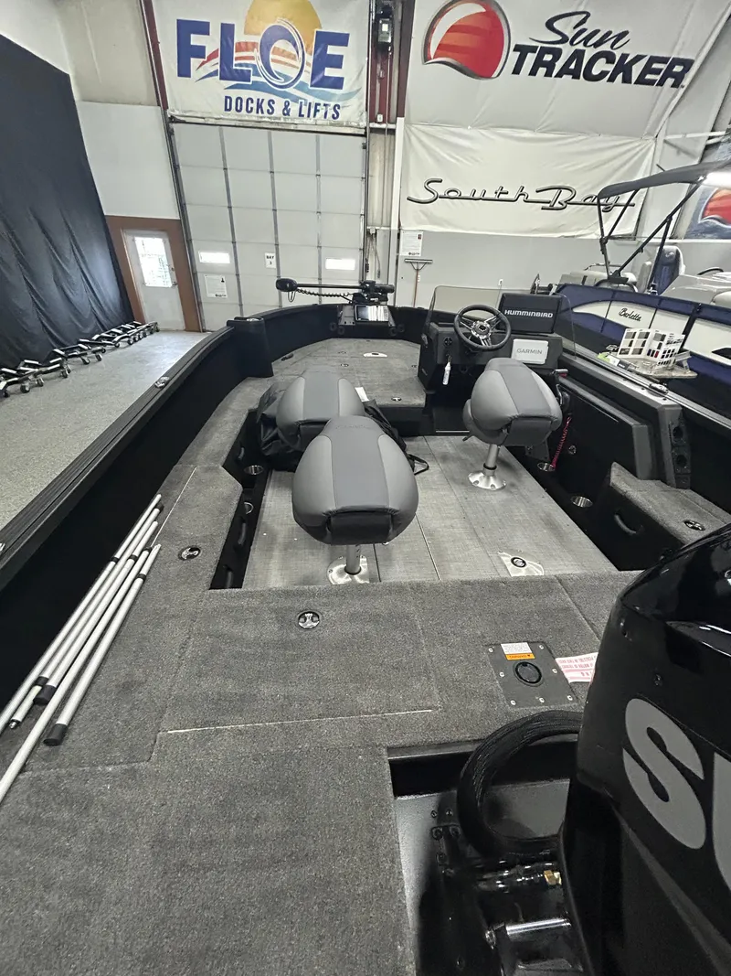 Slide: The Image of 2025 Alumacraft Competitor 175X CS boat interior with steering wheel, Humminbird and Garmin electronics. - 5