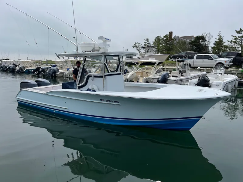 The Image of 2006 Croswait 28CC boat docked in a marina, featuring dual outboard motors. - 0