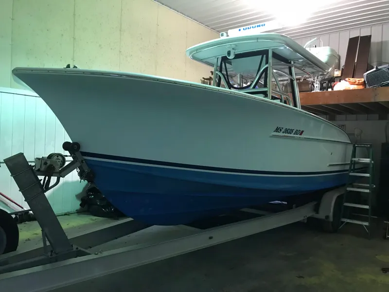 Slide: The Image of 2006 Croswait 28CC boat on trailer in indoor storage. - 2
