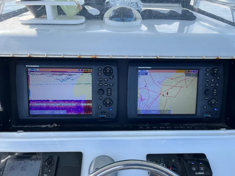 Slide: The Image of Croswait 28CC 2006 boat dashboard with dual navigation screens and controls. - 5