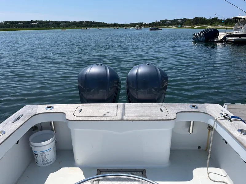 Slide: The Image of 2006 Croswait 28CC boat with dual engines on a calm lake. - 6