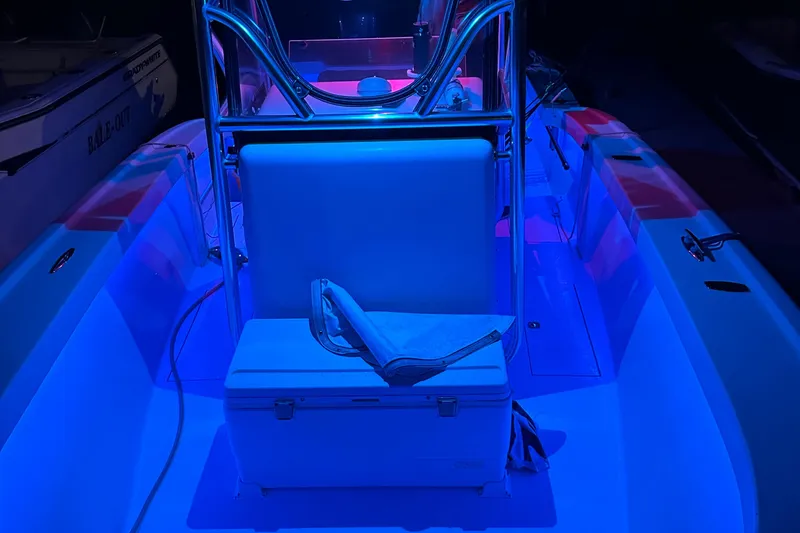 Slide: The Image of Croswait 28CC boat interior with blue LED lighting, featuring a central seat and cooler. - 9