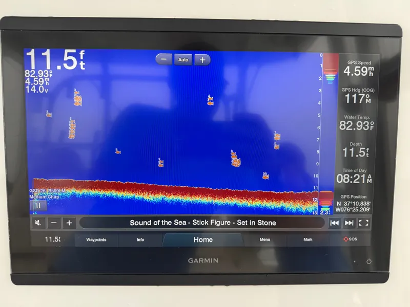 Slide: The Image of A Garmin fishfinder displays depth and GPS data. The screen also shows music and time information. - 6
