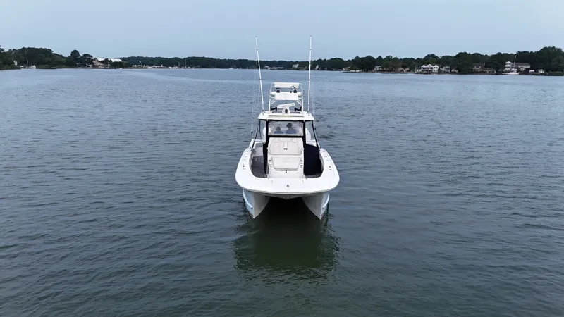 Slide: The Image of 2020 Tideline 365 Offshore on calm water, featuring two antennas and a cabin. - 39