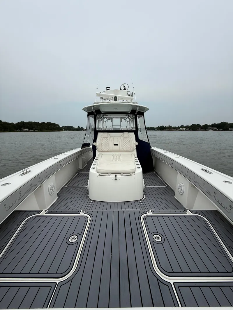 Slide: The Image of The image shows a 2020 Tideline 365 Offshore boat with a spacious deck and sleek cabin. - 23