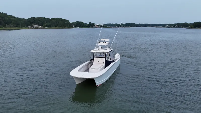 Slide: The Image of A 2020 Tideline 365 Offshore boat on calm water with two fishing rod holders. - 38