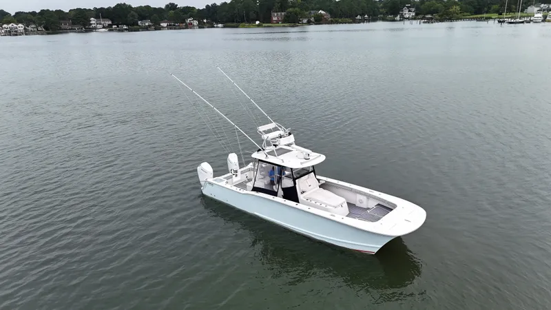 Slide: The Image of A 2020 Tideline 365 Offshore boat on calm water with two outboard engines and fishing rods. - 37