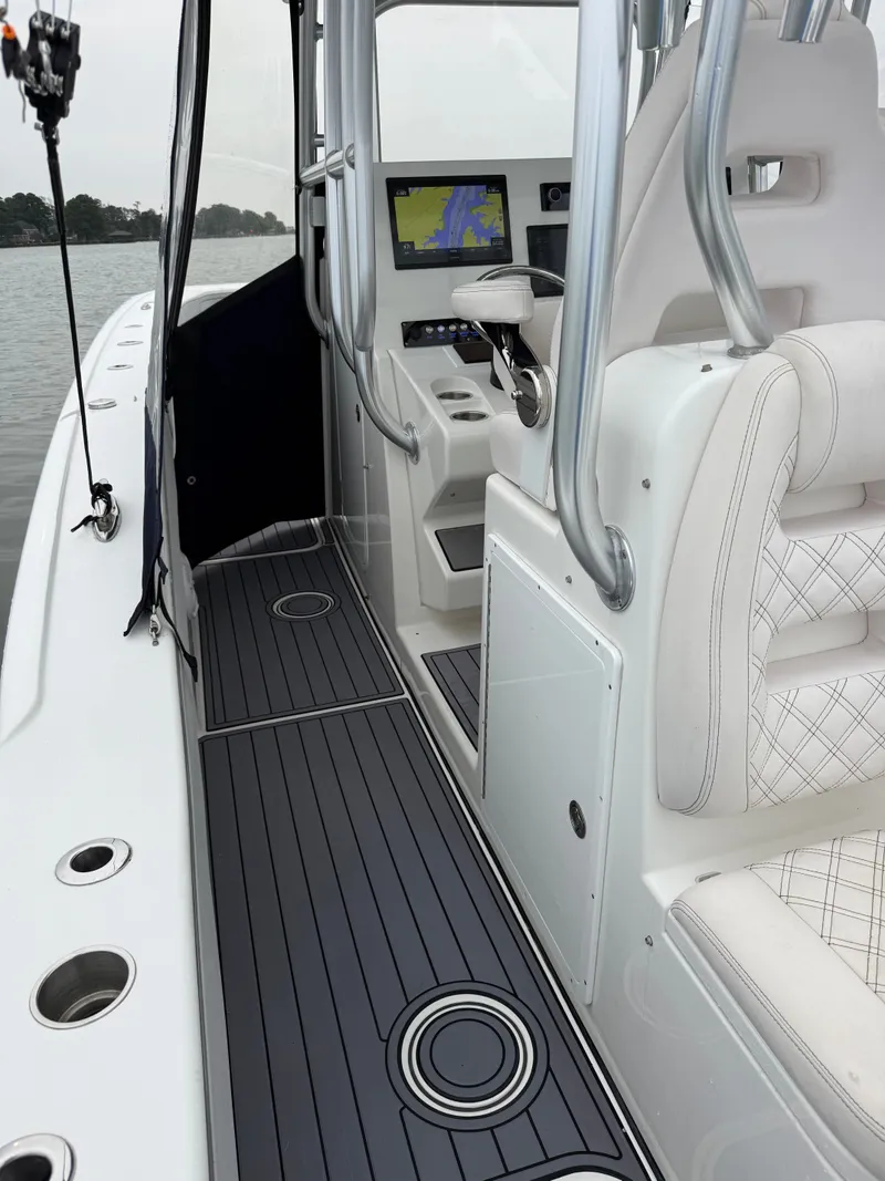 Slide: The Image of The image shows the cockpit of a 2020 Tideline 365 Offshore boat with modern navigation systems. - 19