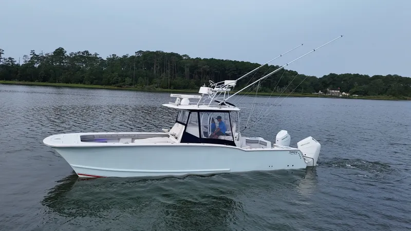 Slide: The Image of A white boat cruising on calm water, featuring two outboard engines and fishing rods. - 45