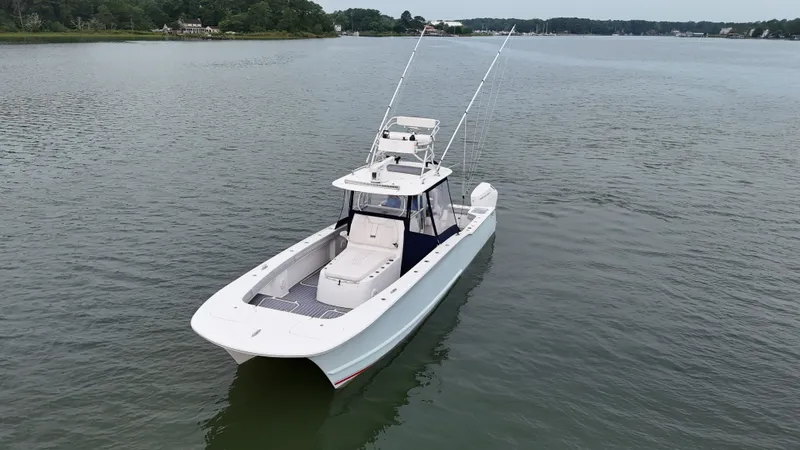 Slide: The Image of A white boat calmly floats on a wide river or lake, surrounded by green shores. - 36