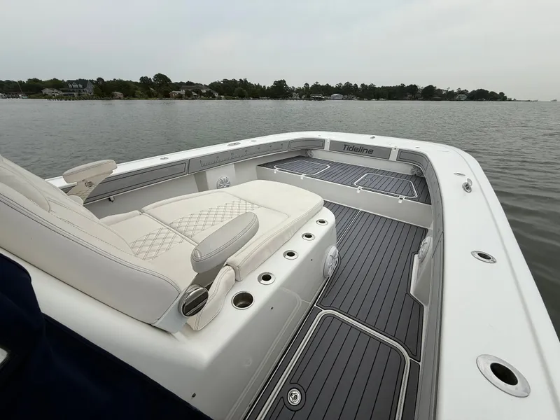 Slide: The Image of The image shows a 2020 Tideline 365 Offshore boat with elegant seating and a spacious deck. - 20