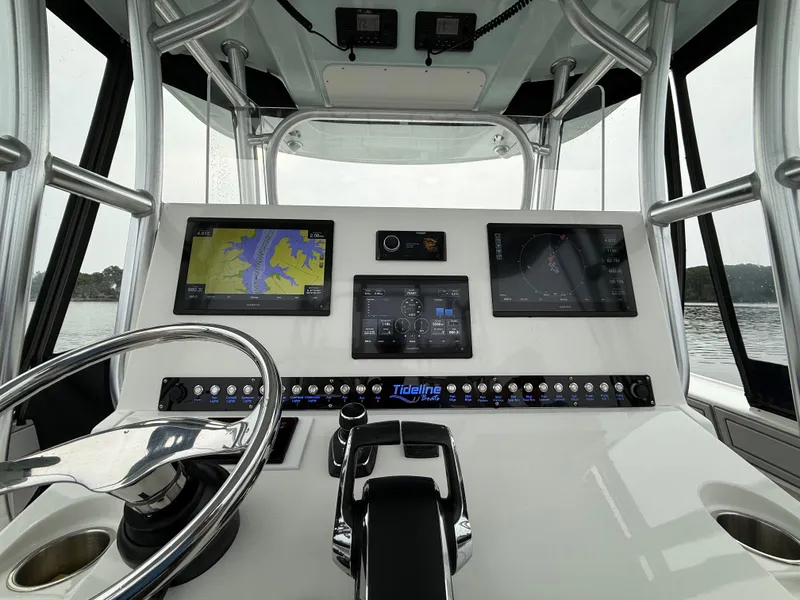 Slide: The Image of The image shows the helm of a 2020 Tideline 365 Offshore with multiple screens and controls. - 5