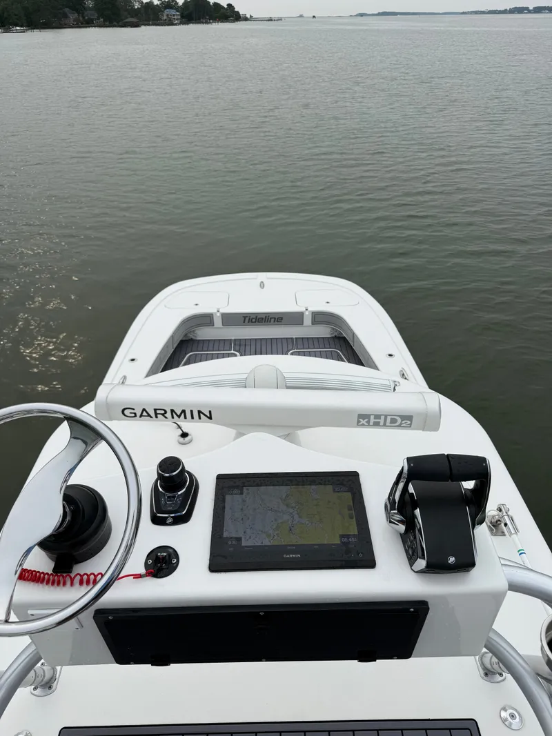 Slide: The Image of The image shows the helm of a 2020 Tideline 365 Offshore boat with Garmin navigation. - 33