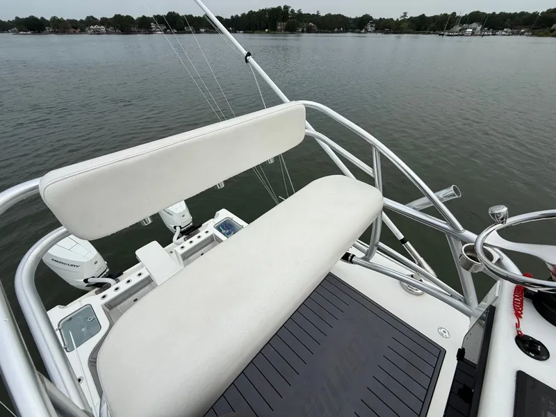 Slide: The Image of The image shows the helm of a 2020 Tideline 365 Offshore overlooking calm waters. - 34