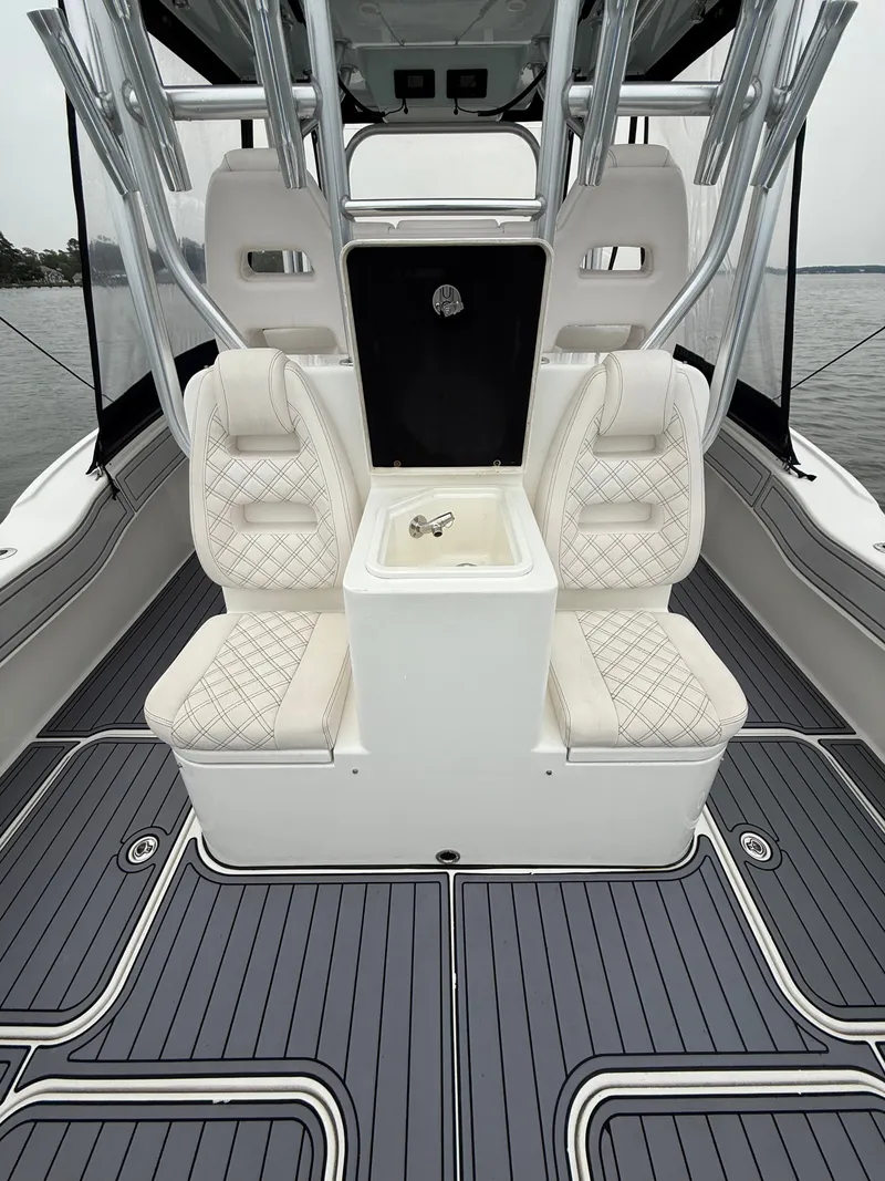 Slide: The Image of The image shows the cockpit of a 2020 Tideline 365 Offshore boat with elegant seating and a central table. - 15