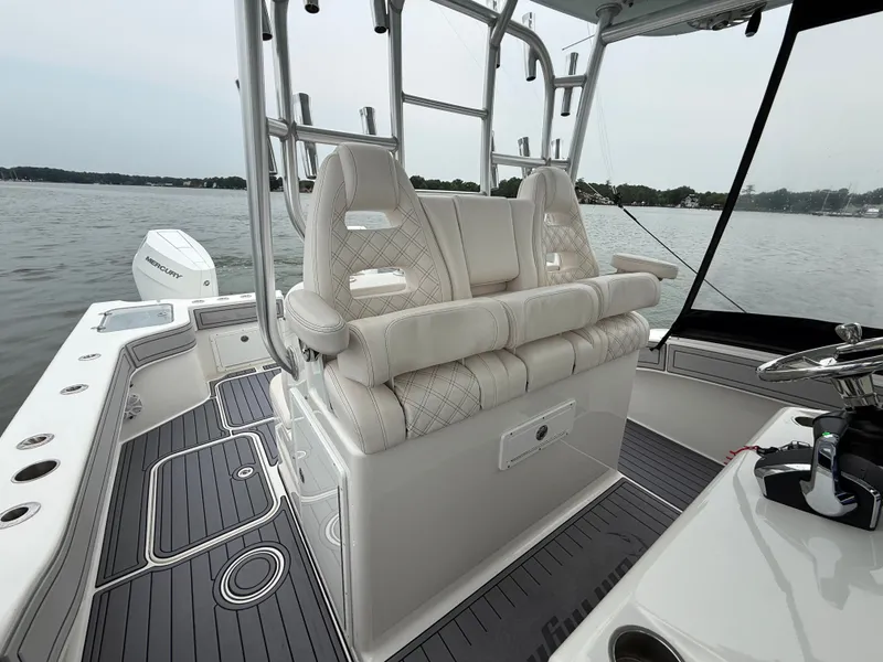 Slide: The Image of The image shows the cockpit of a 2020 Tideline 365 Offshore with luxurious seating and gray flooring. - 8