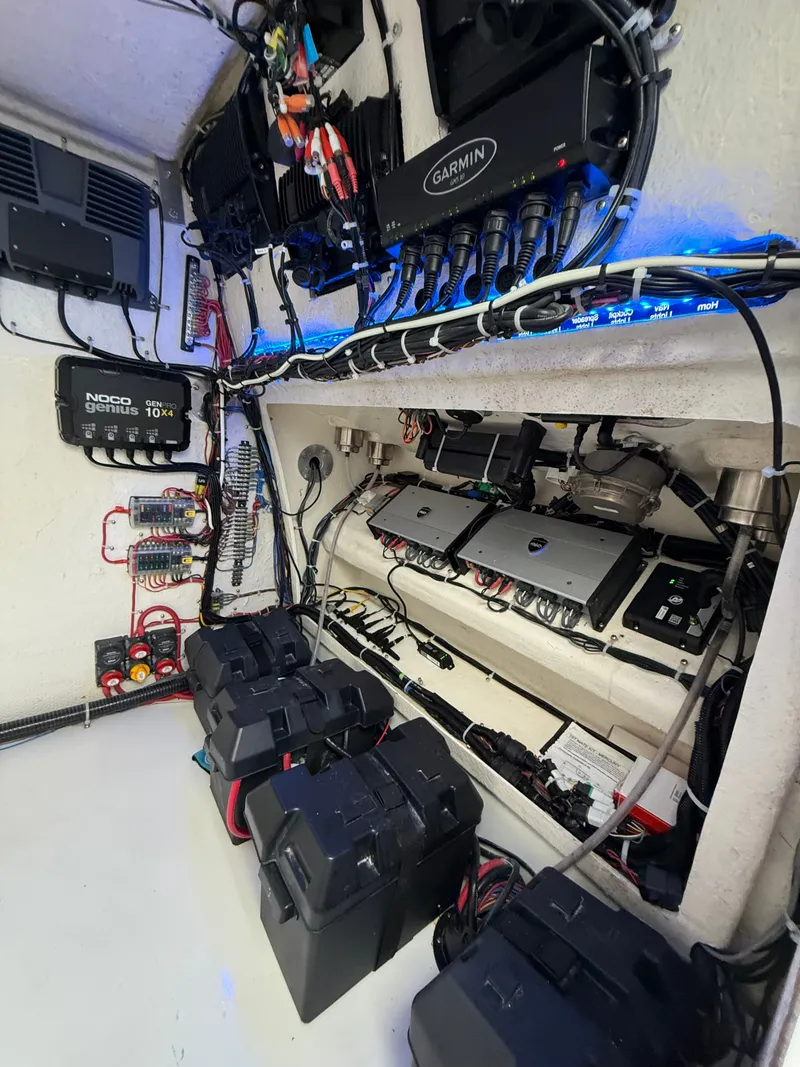 Slide: The Image of Electronics and battery systems inside a boat, featuring multiple cables and devices. - 31