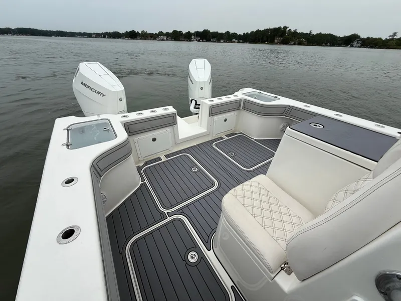 Slide: The Image of The image shows the stern of a 2020 Tideline 365 Offshore with a gray deck and two Mercury engines. - 9