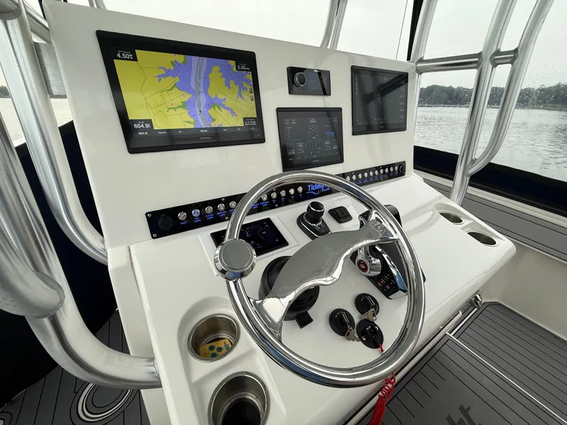 Slide: The Image of The image shows the helm of a 2020 Tideline 365 Offshore with modern navigation systems. - 4