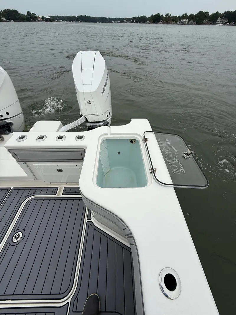 Slide: The Image of The image shows the stern of a 2020 Tideline 365 Offshore with two outboard motors. - 16
