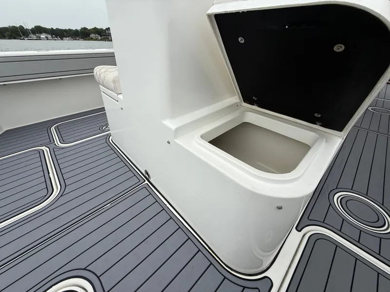 Slide: The Image of The image shows the deck of a 2020 Tideline 365 Offshore with an open storage compartment. - 14