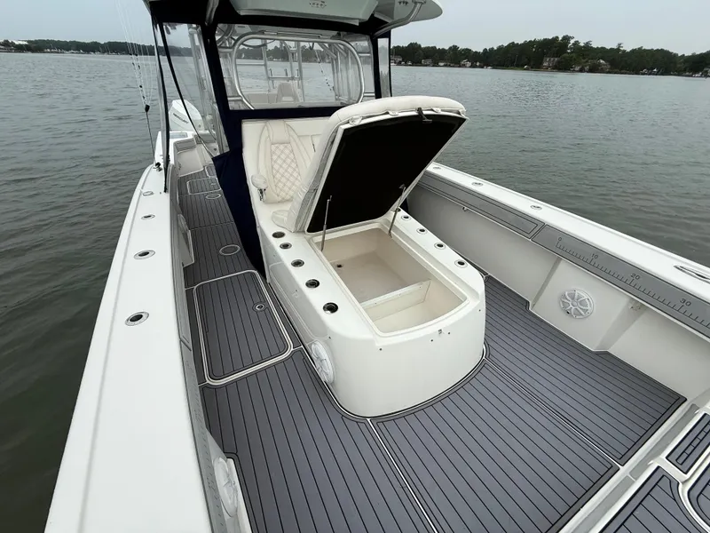 Slide: The Image of The image shows a 2020 Tideline 365 Offshore boat with an open storage compartment on the deck. - 27