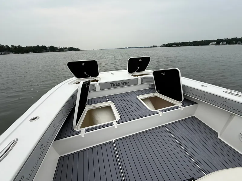 Slide: The Image of The image shows the deck of a 2020 Tideline 365 Offshore with open storage compartments. - 25
