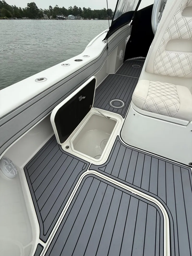 Slide: The Image of The image shows the deck of a 2020 Tideline 365 Offshore with gray flooring and white seating. - 29