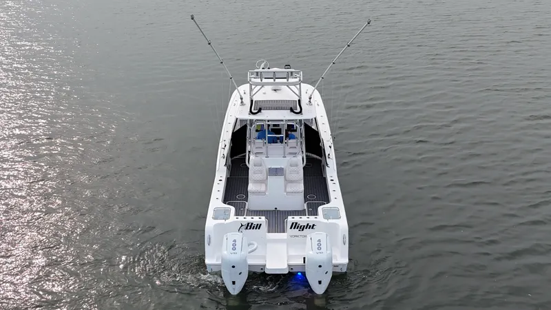 Slide: The Image of The image shows a 2020 Tideline 365 Offshore boat on calm water. It features twin outboard engines. - 42