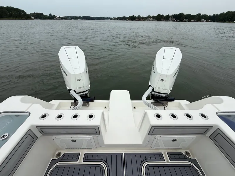 Slide: The Image of The image shows the stern of a 2020 Tideline 365 Offshore with two outboard engines. - 13